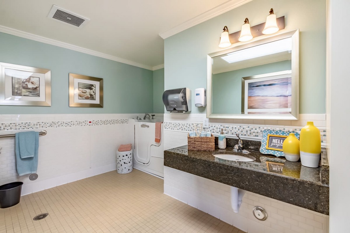 A well-lit bathroom with a modern vanity, large mirror, and tasteful decor.