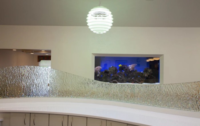 A modern interior with a decorative aquarium and minimalist lighting.