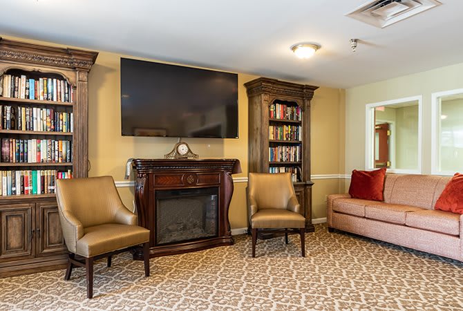 Cozy living room with a fireplace, television, and comfortable seating.