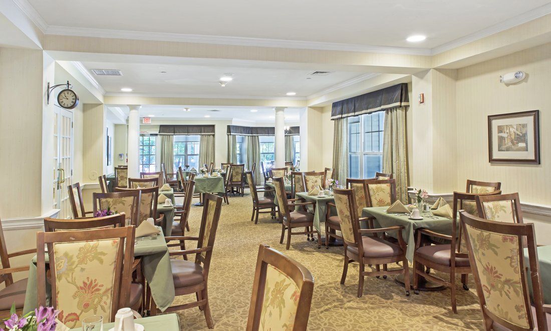 An elegant dining room with neatly arranged tables and chairs, ready for guests.