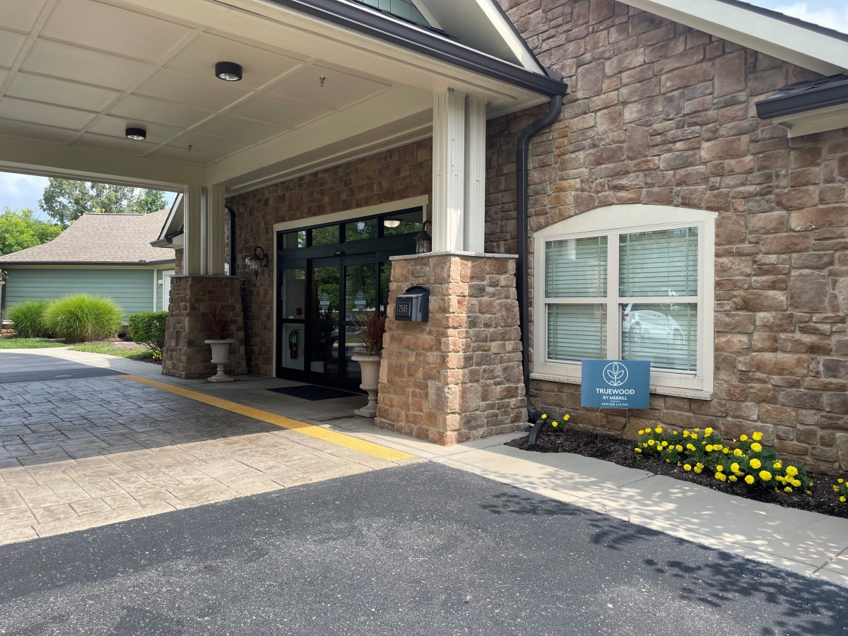 Entrance to a building with a stone facade and glass doors.