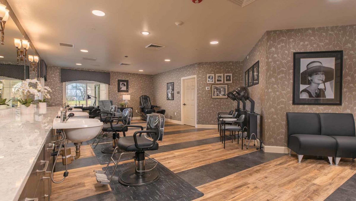 A modern salon interior with styling chairs and mirrors.
