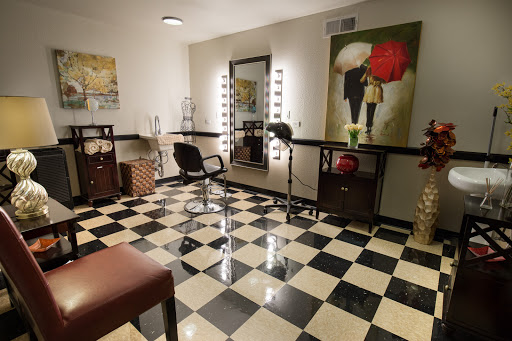 A modern hair salon featuring a stylish black and white checkered floor and elegant decor.