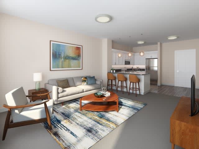 A modern open-concept living room with a stylish kitchen island and vibrant artwork.