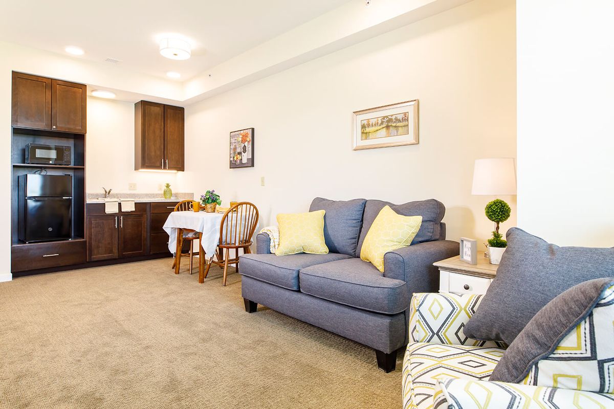 Cozy living room with a comfortable sofa, dining area, and kitchenette.