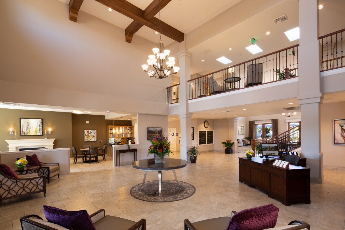 Spacious and elegantly designed lobby with modern decor and a prominent chandelier.