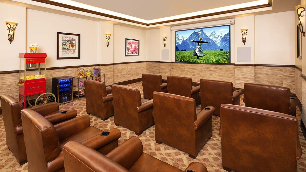 Comfortable home theater setup with recliner seating and a large screen.