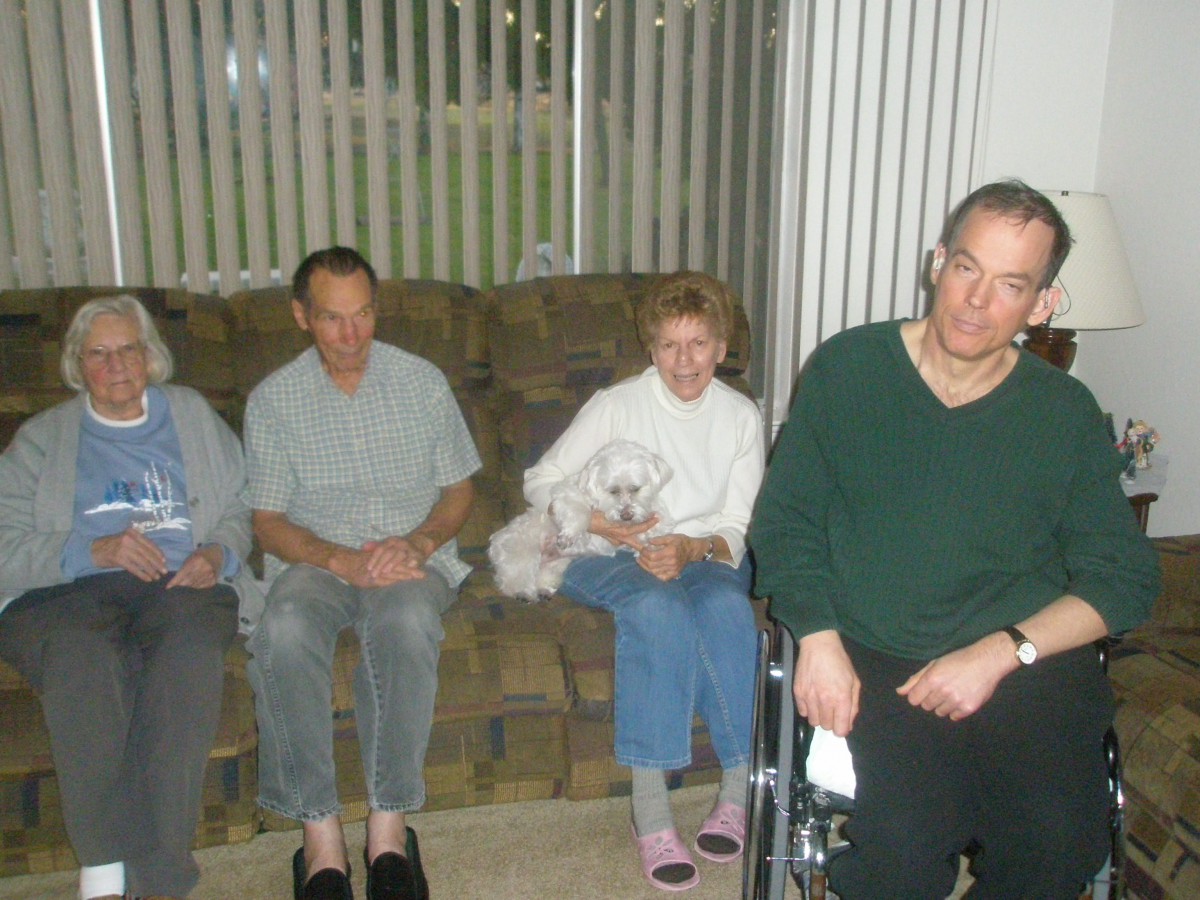 A group of people sitting indoors in a living room setting.