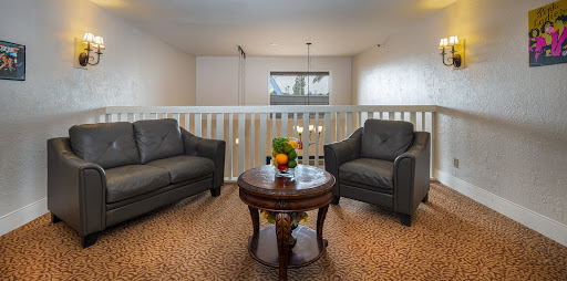 A cozy living room setup featuring two stylish chairs and a coffee table adorned with fresh fruit.