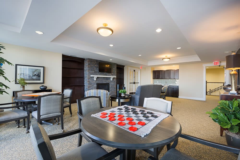 A spacious living room with elegant furniture and a board game set up on the table.