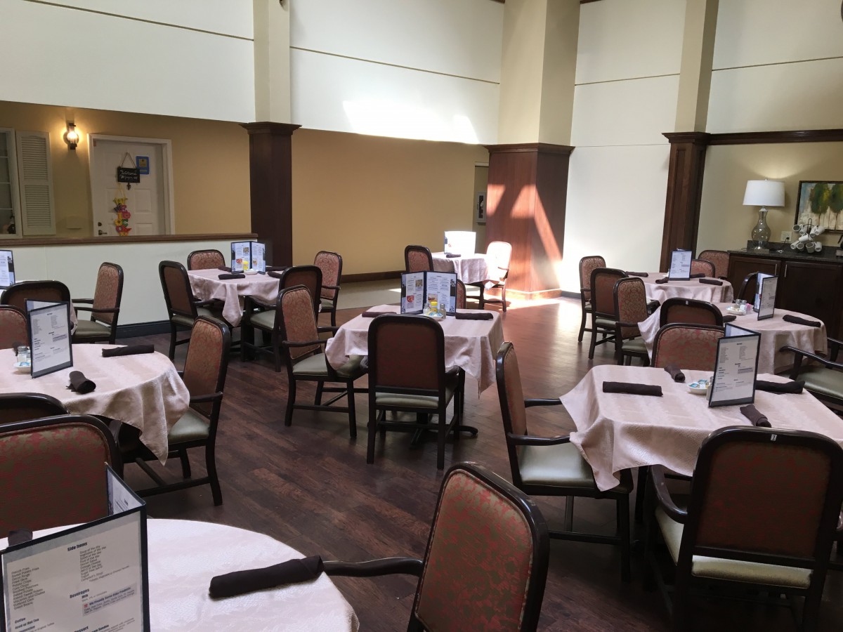An elegant restaurant dining area with neatly arranged tables and chairs.