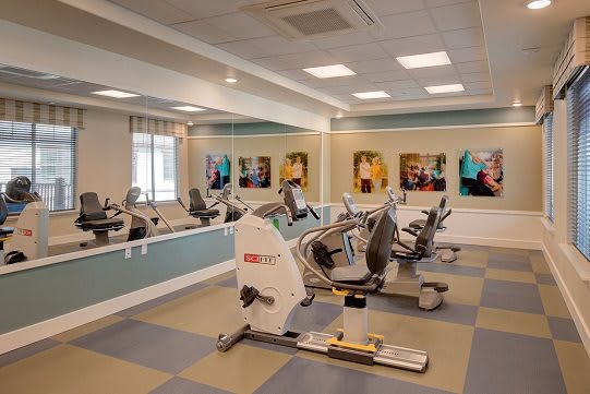 A modern gym with exercise bikes and fitness equipment.