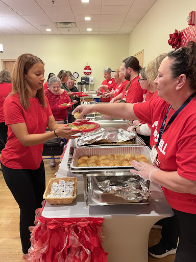 Volunteers serving food at a community holiday event.
