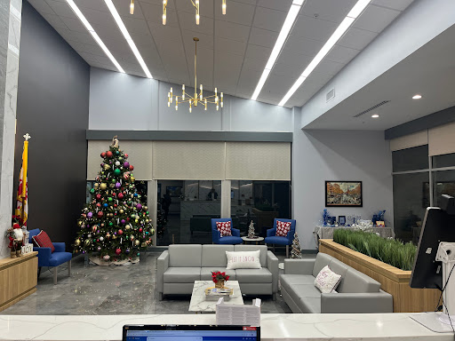 A stylish modern lobby decorated for the holiday season, featuring a beautifully adorned Christmas tree and comfortable seating arrangements.