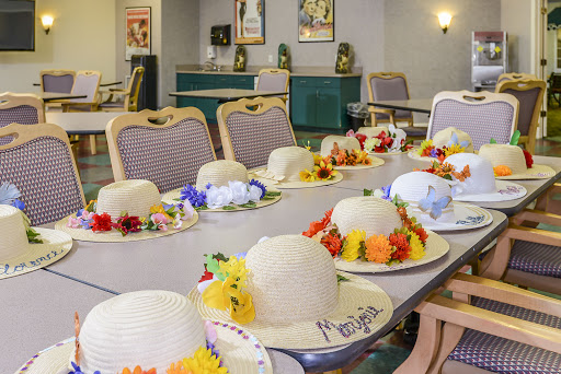 A colorful table setting adorned with decorated hats and flowers, ready for a festive celebration.