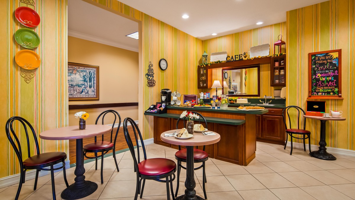 A cozy cafe with a coffee station and seating area.