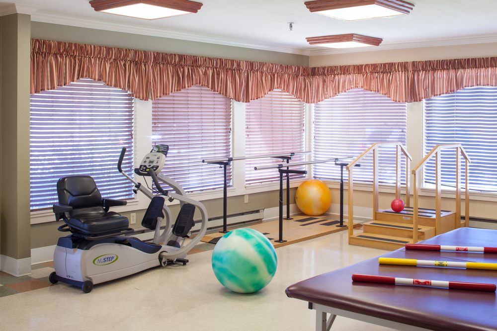 A well-equipped physical therapy room with various exercise equipment.