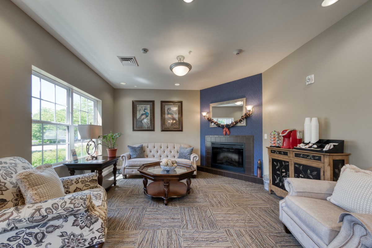 A cozy living room with elegant furnishings and a fireplace.