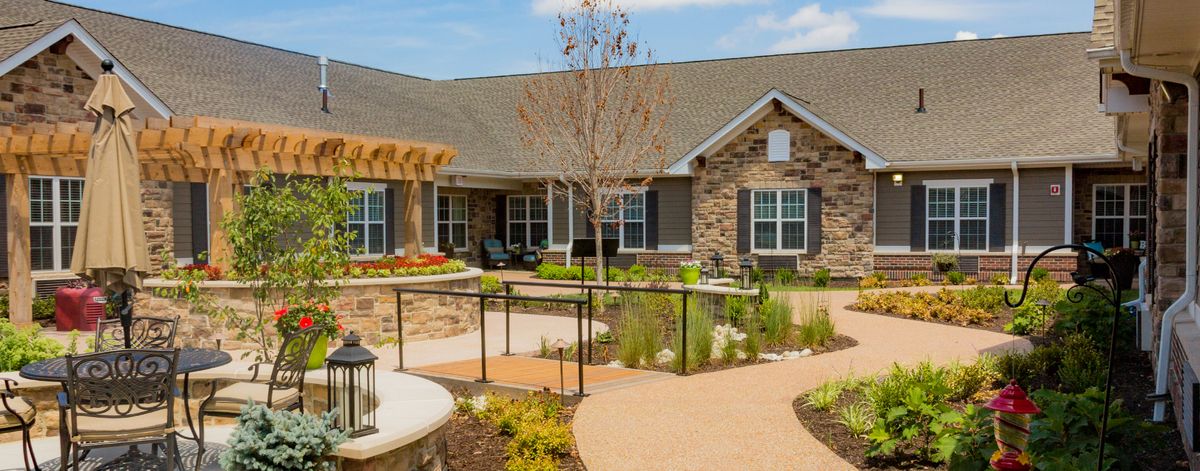 A beautifully landscaped single-story house with a well-maintained garden and pathway.