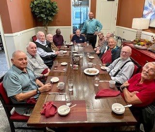 A group of people gathered around a dining table for a meal.