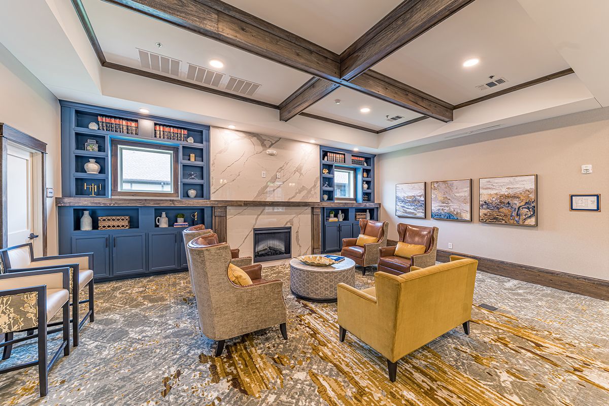 A cozy living room featuring a fireplace, comfortable seating, and modern decor.