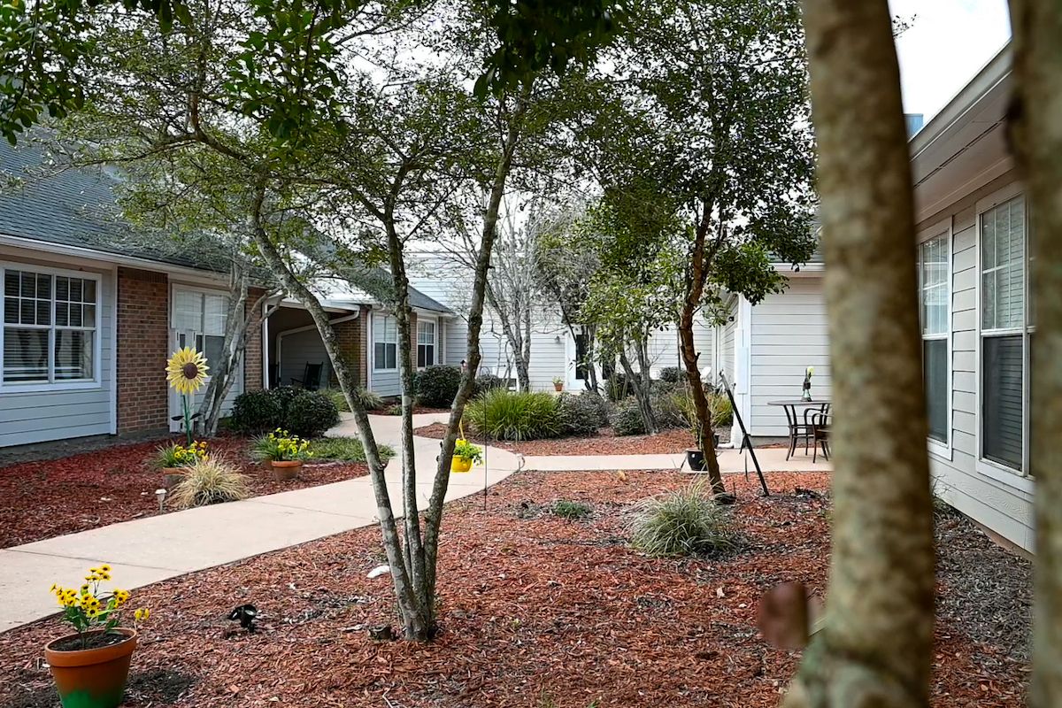 A peaceful residential area with a landscaped garden and pathway.