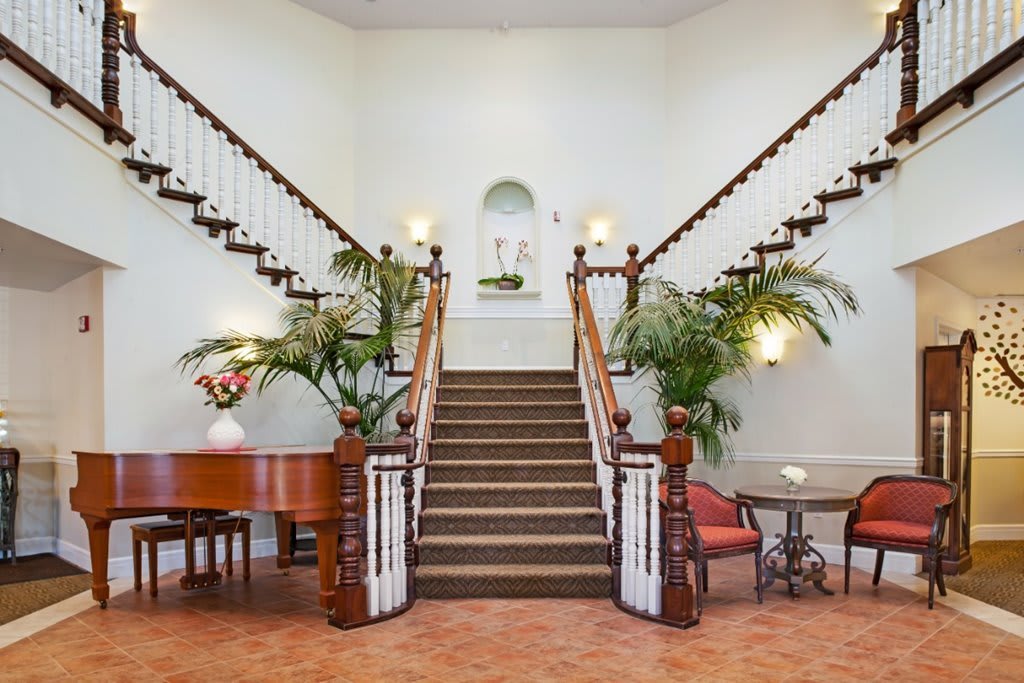 A beautifully elegant interior with a grand staircase and traditional decor.