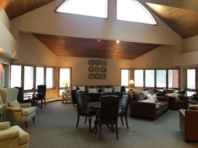 A spacious living room featuring ample seating and large windows allowing natural light to flood in.