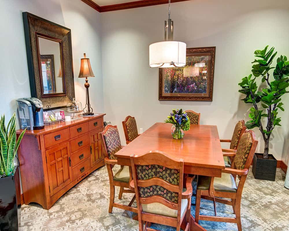 A cozy dining room with a wooden table and chairs, complemented by elegant decor and artwork.