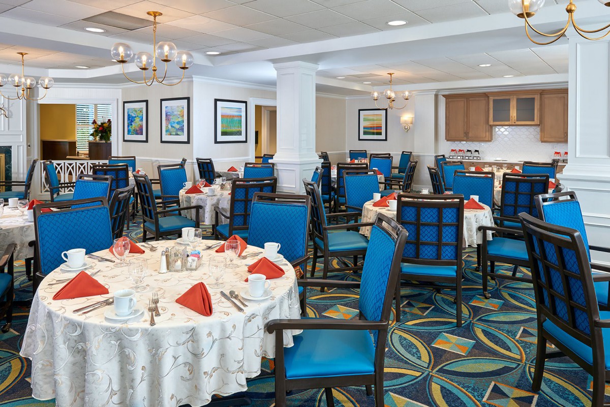 A well-decorated dining room with tables set for a meal.