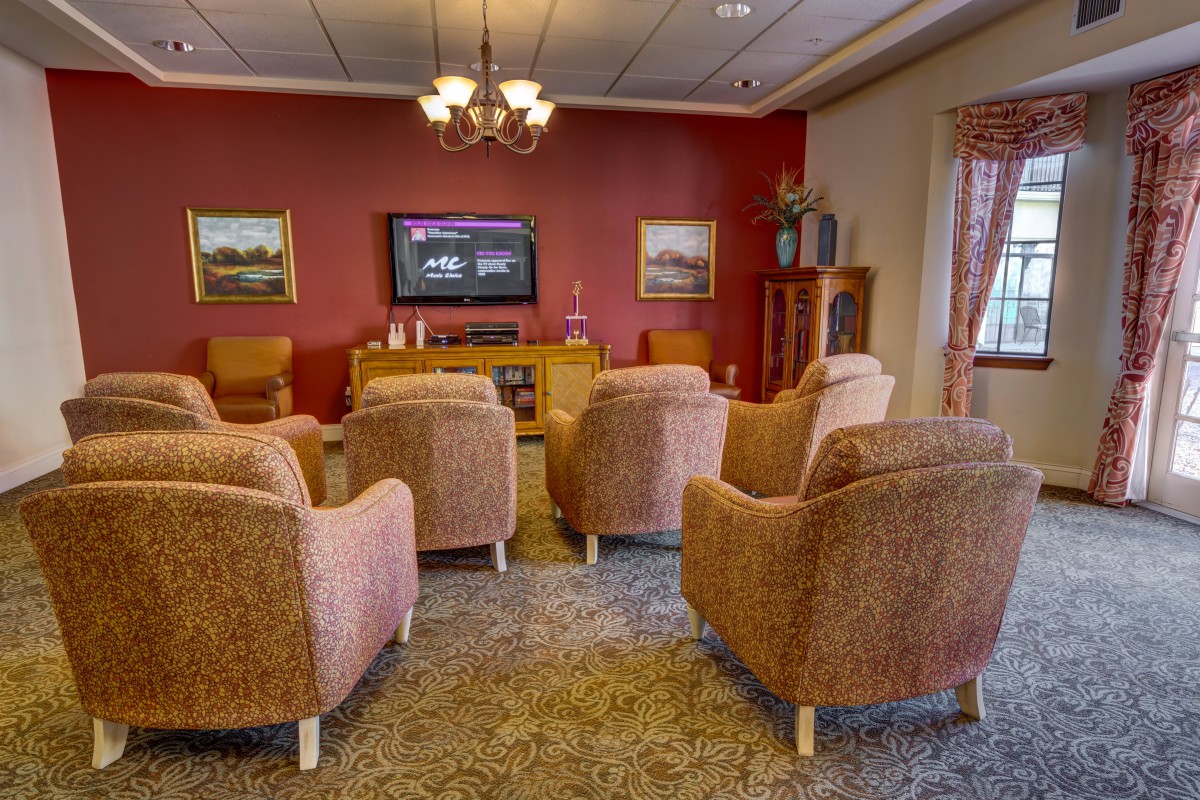 A cozy living room with comfortable chairs arranged around a television.