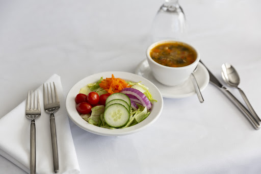 A healthy lunch featuring a fresh salad and vegetable soup.