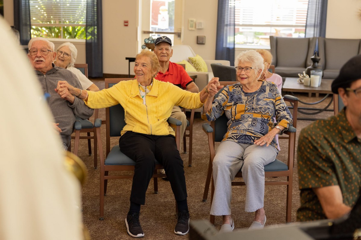 A group of seniors enjoying a social activity together in a community center.