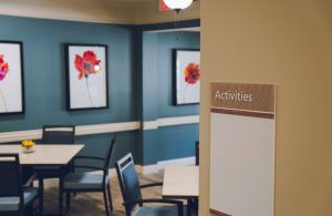 A cozy room with seating and floral artwork, labeled for activities.