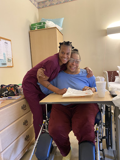 A warm moment between a caregiver and patient, showcasing compassion and support in a hospital setting.