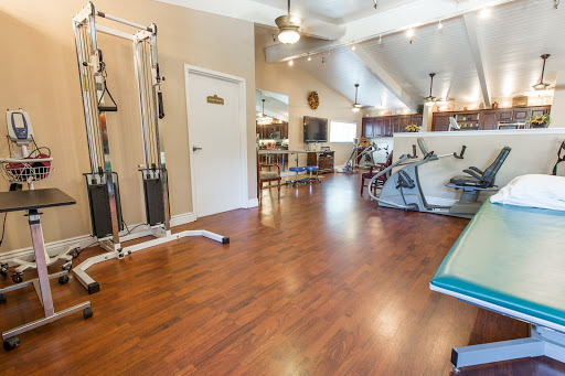 A spacious and well-equipped gym area designed for fitness and rehabilitation activities.