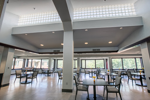 A bright and spacious dining area featuring modern furnishings and ample natural light.