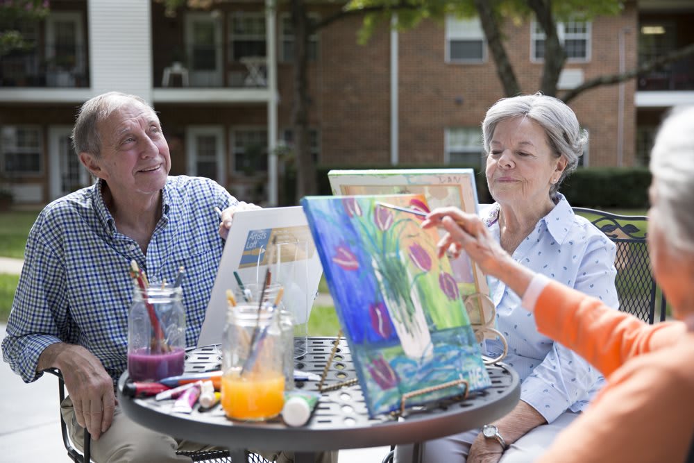 Seniors enjoying an outdoor painting session.