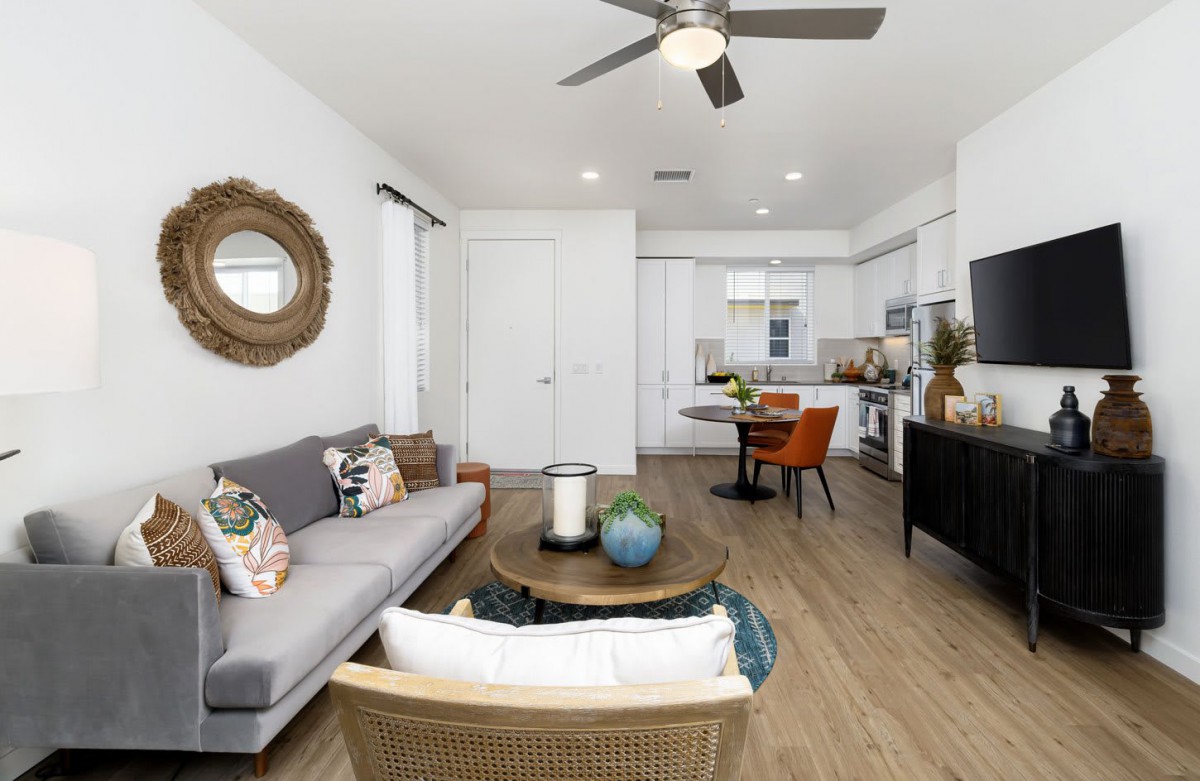 A modern living room with stylish furniture and wooden flooring.