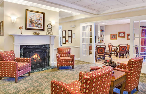 A cozy living room setting featuring comfortable armchairs and a warm fireplace.