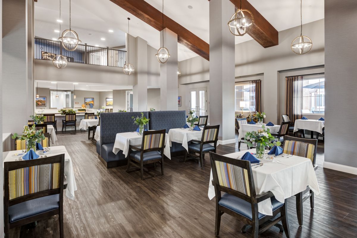 A modern and elegantly designed restaurant interior with neatly arranged tables and chairs.