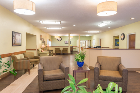 A welcoming lobby with comfortable seating and a touch of greenery.