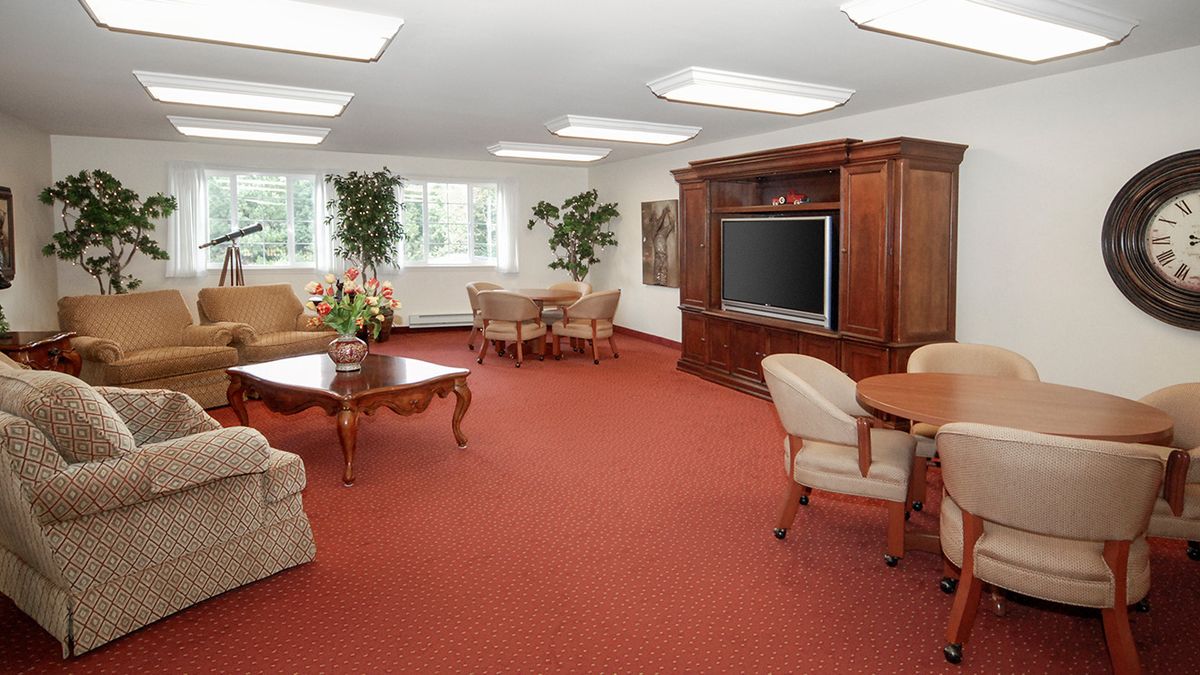 A spacious living room with comfortable seating and a large television.