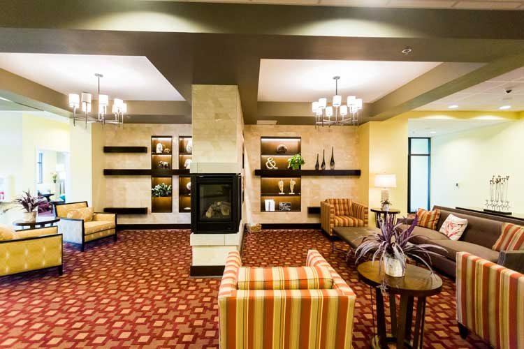 A cozy lounge area with modern furniture and a fireplace.