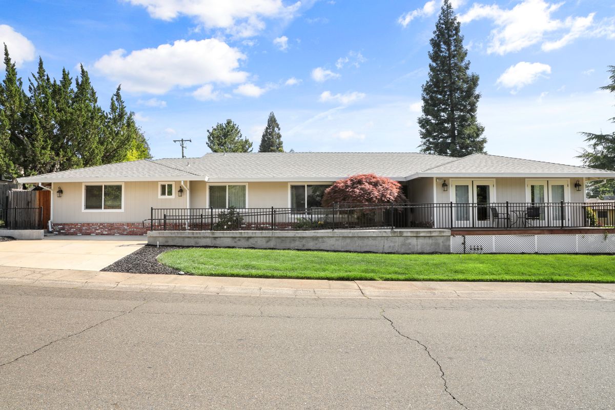 A single-story ranch-style house with a well-maintained front yard and driveway, set in a suburban area.
