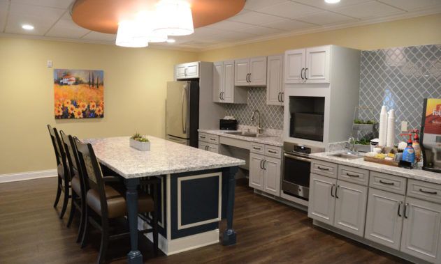 A modern kitchen featuring an island with seating, sleek cabinets, and contemporary appliances.
