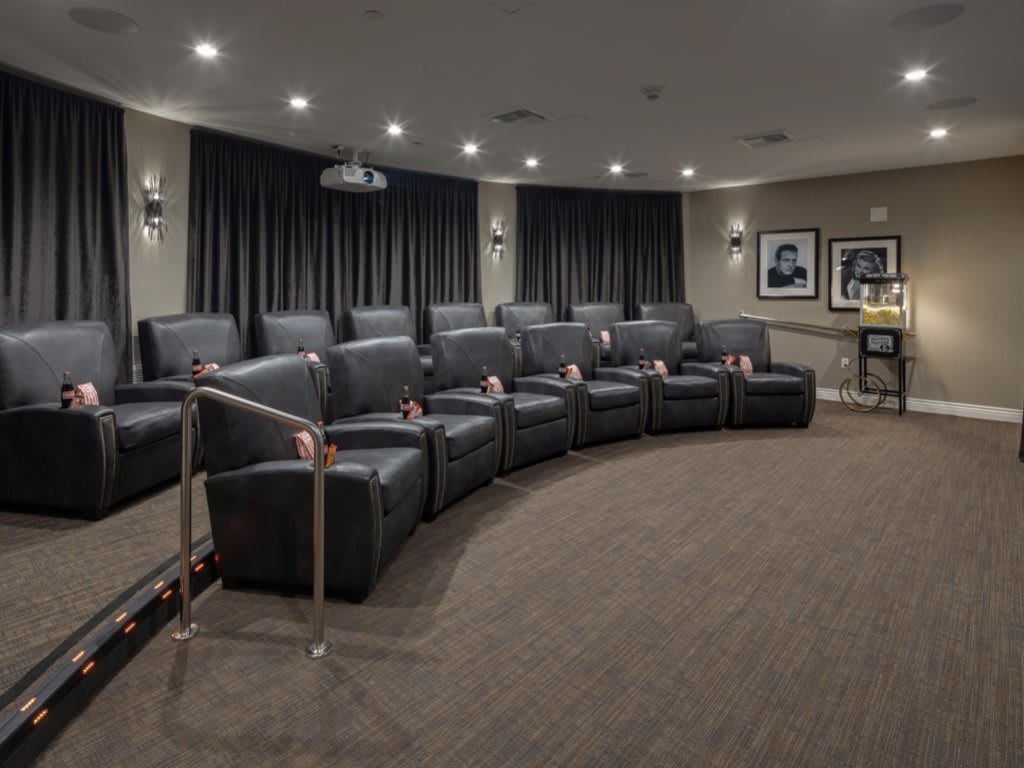 A luxury home theater with comfortable recliner seating and elegant decor.