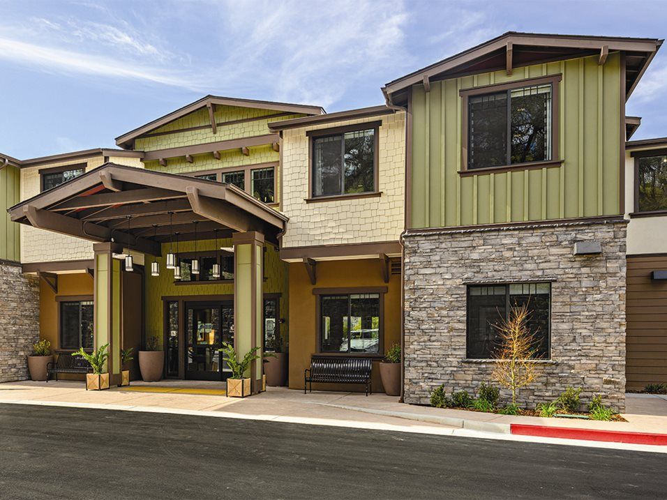 Modern residential building with a stone facade and welcoming entrance.