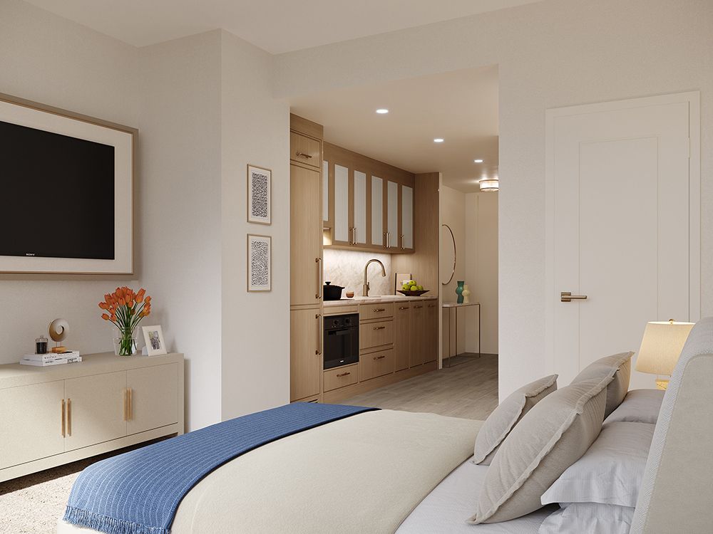 A modern and minimalist bedroom with a view of a kitchenette, featuring neutral tones and decorative art on the walls.