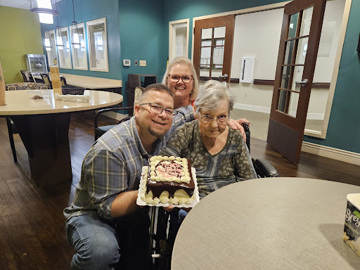 A joyful birthday celebration with family, featuring a delicious cake shared in a warm setting.